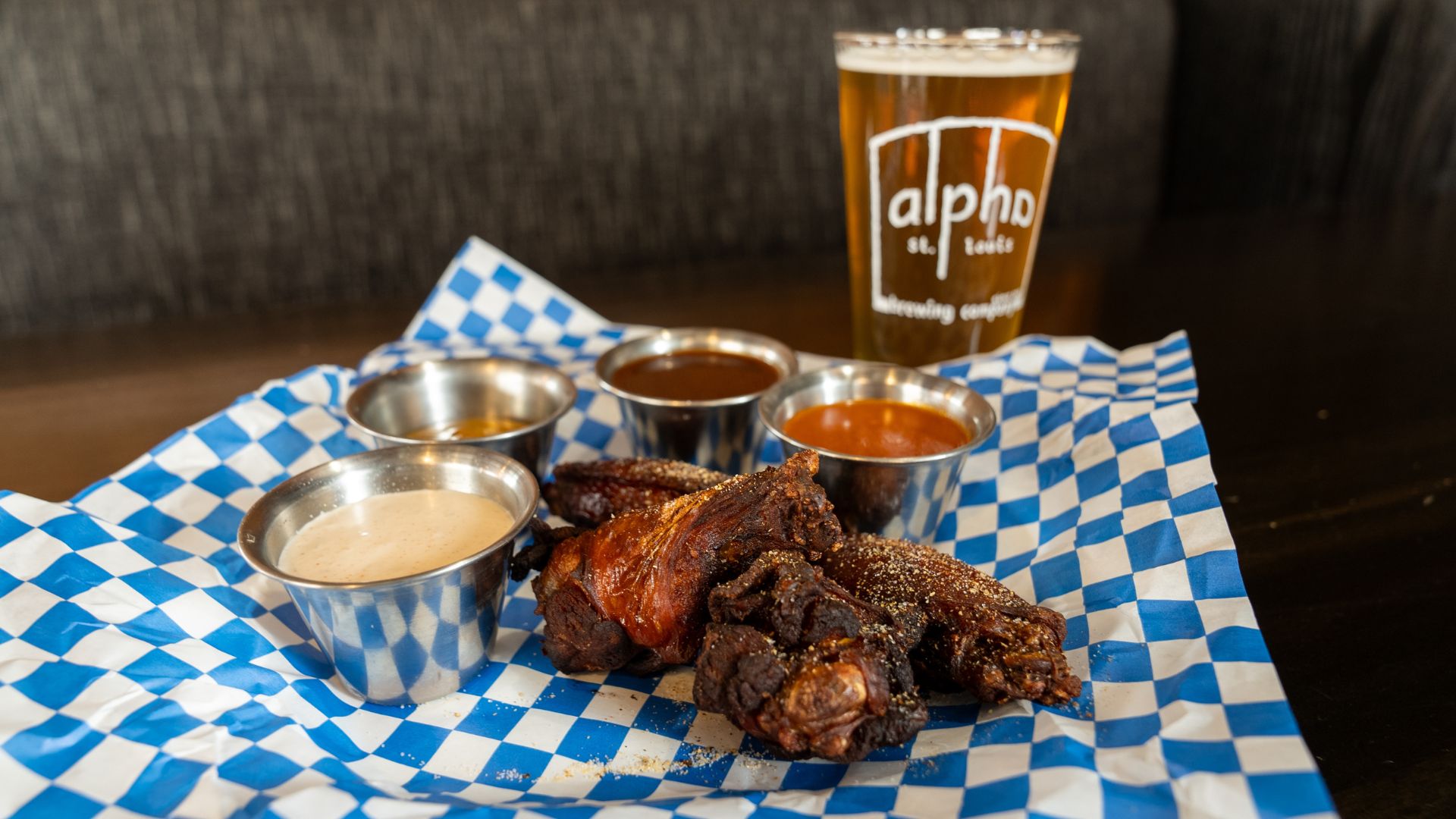 Alpha Brewing Company serves chicken wings alongside its sour beers.