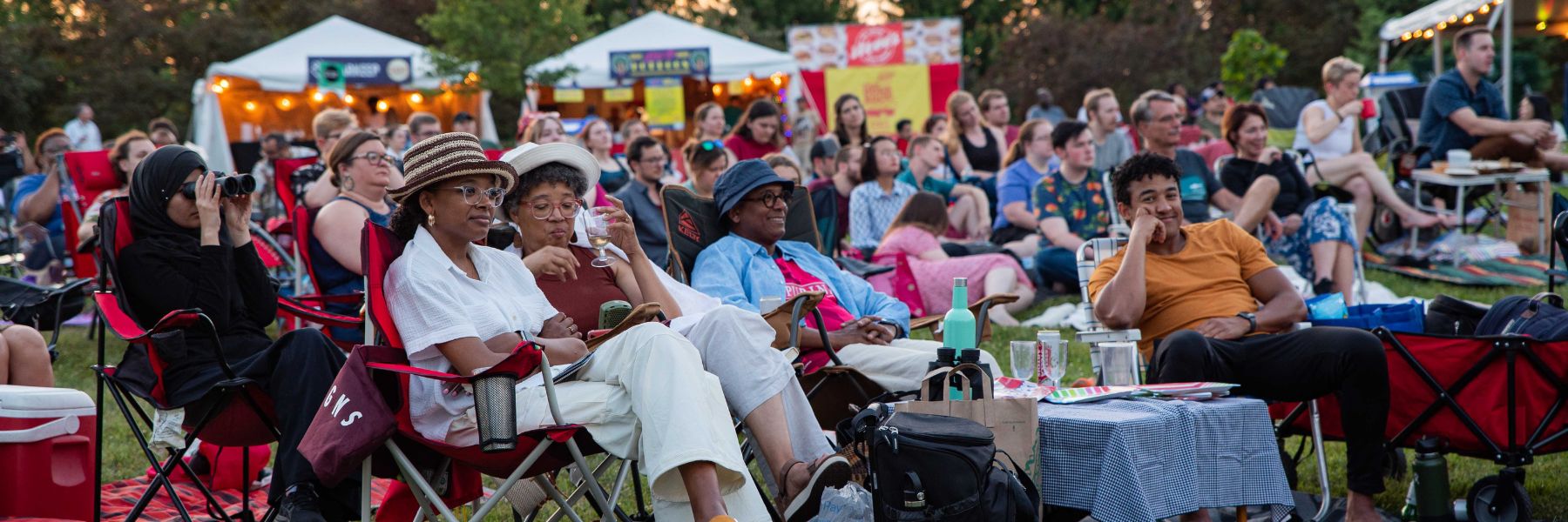 A diverse audience watches a performance during the St. Louis Shakespeare Festival.
