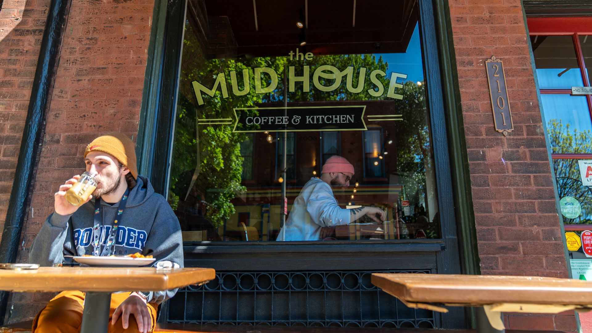 Patrons enjoy coffee inside and outside The Mud House.