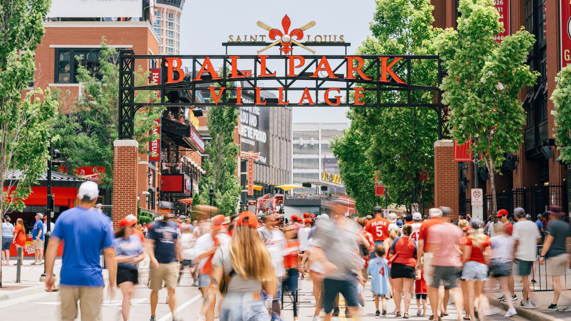 People mill about Ballpark Village in St. Louis.