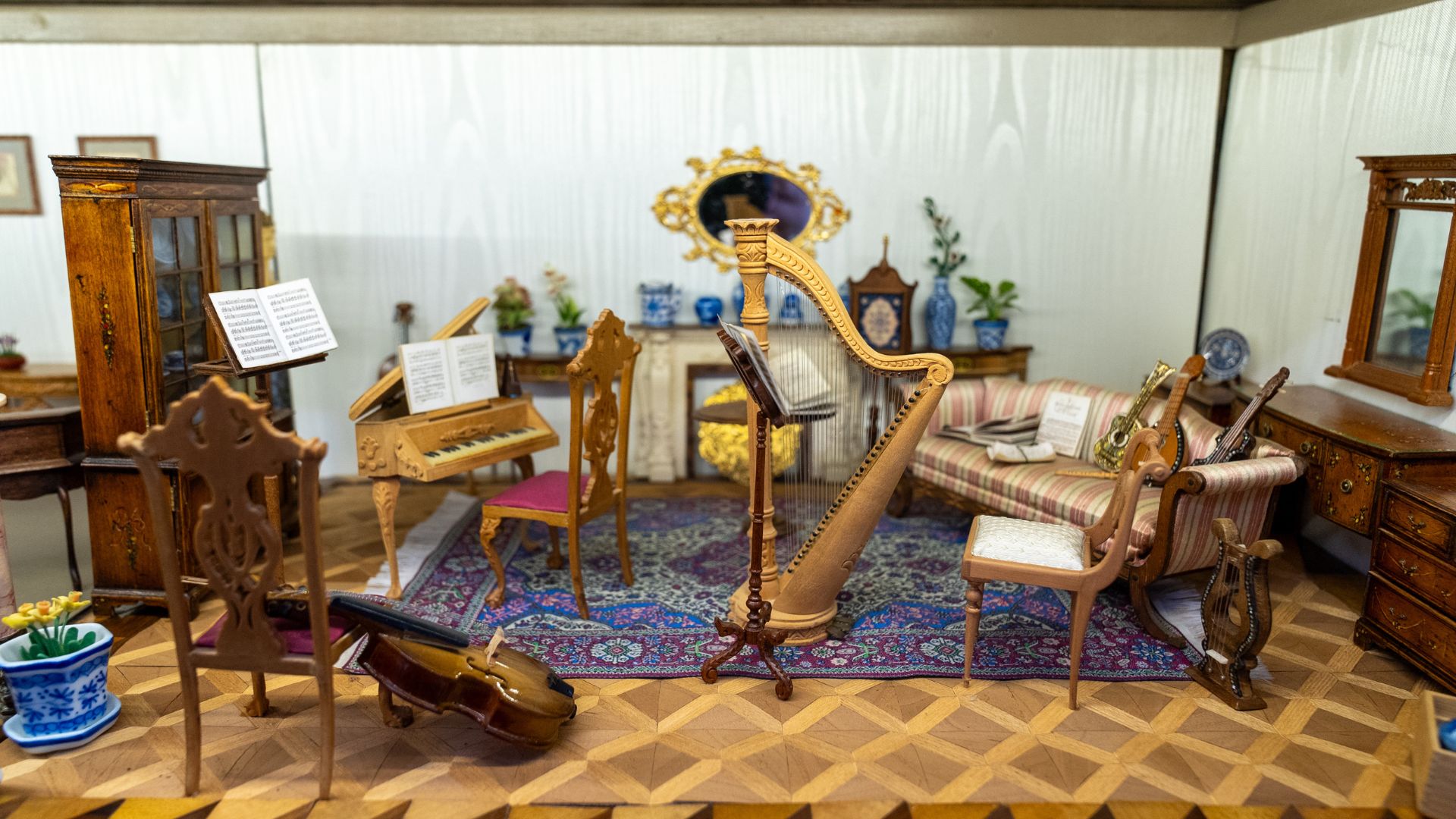 Miniature instruments fill a room box.