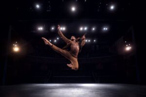 A dance leaps through the air during a performance for Saint Louis Dance Theatre.