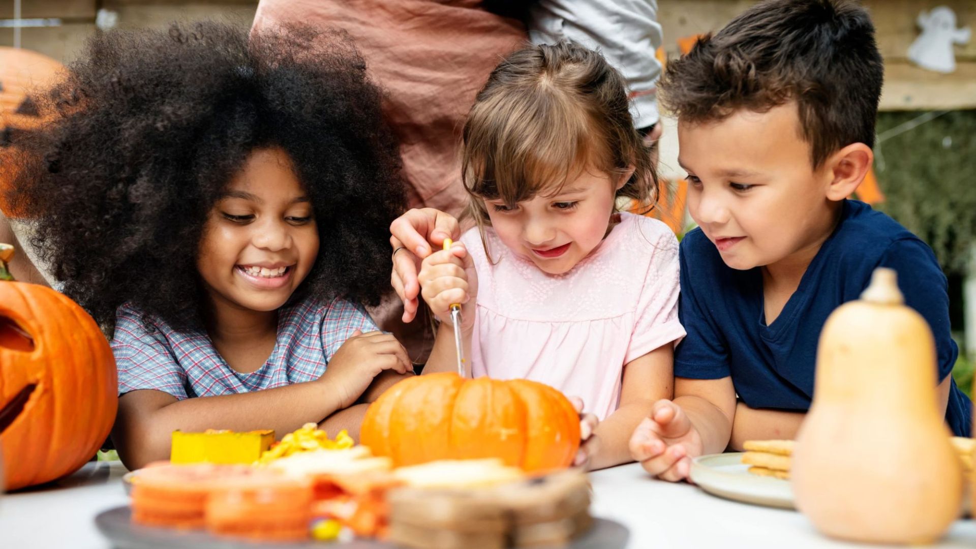 Kids carve pumpkins after visiting a pumpkin patch in St. Louis.