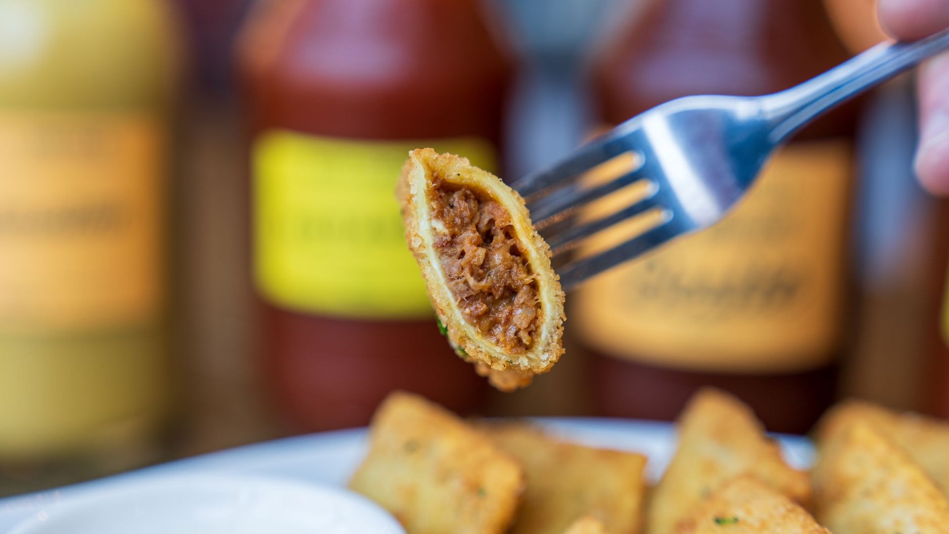 A diner digs into burnt end toasted ravioli at Salt + Smoke.