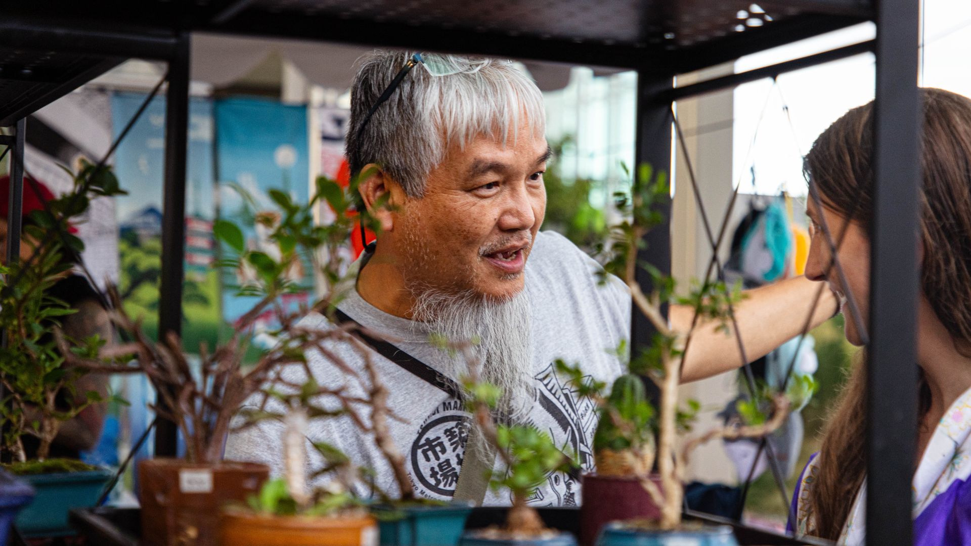 A Japanese vendor shows off his plants at the Japanese Festival at the Missouri Botanical Garden.