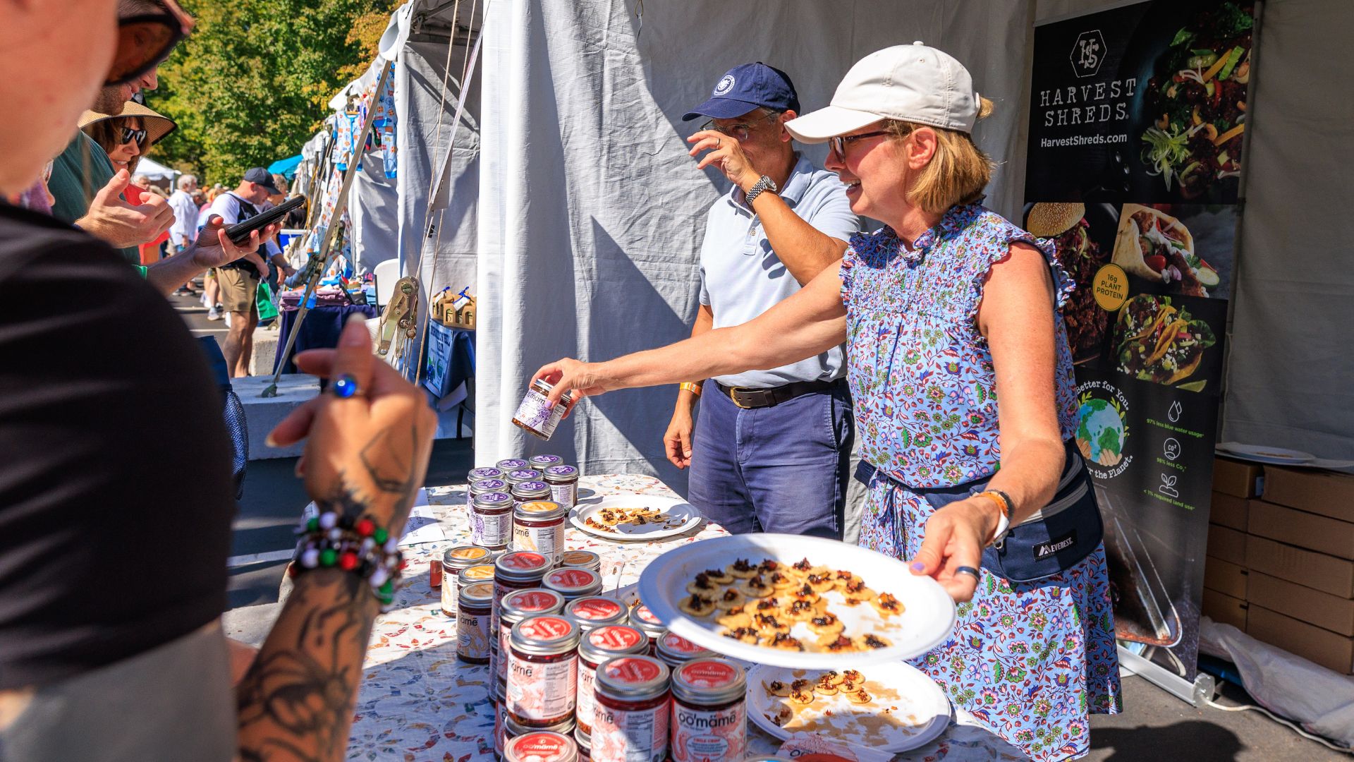 Diverse people shop for chili crisp at the Best of Missouri Market at the Missouri Botanical Garden.