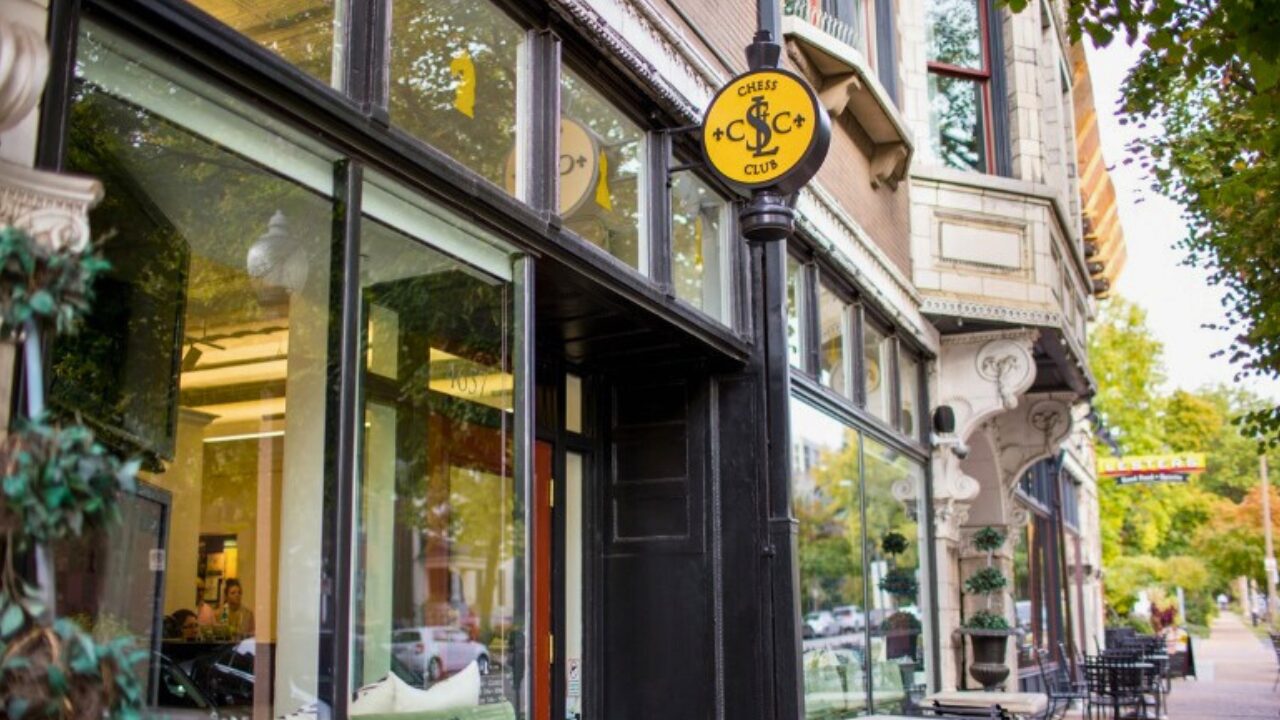 Exterior of the Saint Louis Chess Club in the Central West End featuring the iconic yellow and black circular street sign.