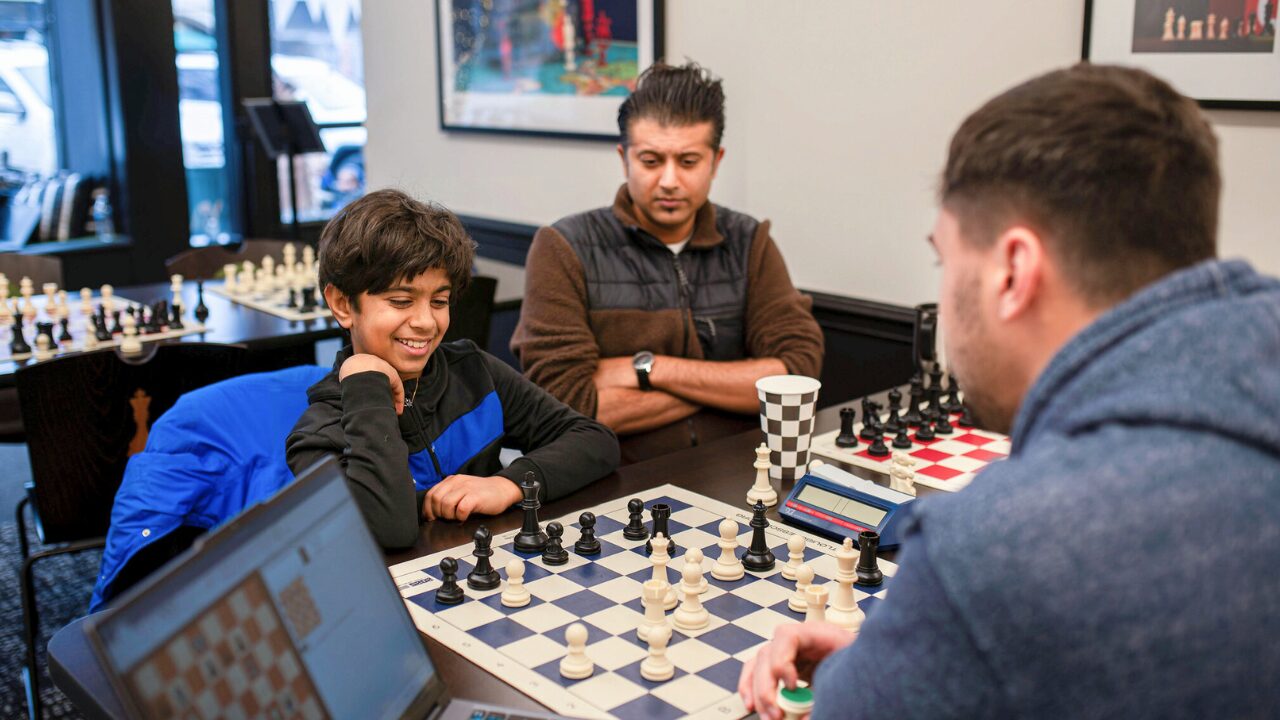 Students and adults engaged in a chess match at the Saint Louis Chess Club, a premier venue for tournaments and casual play.