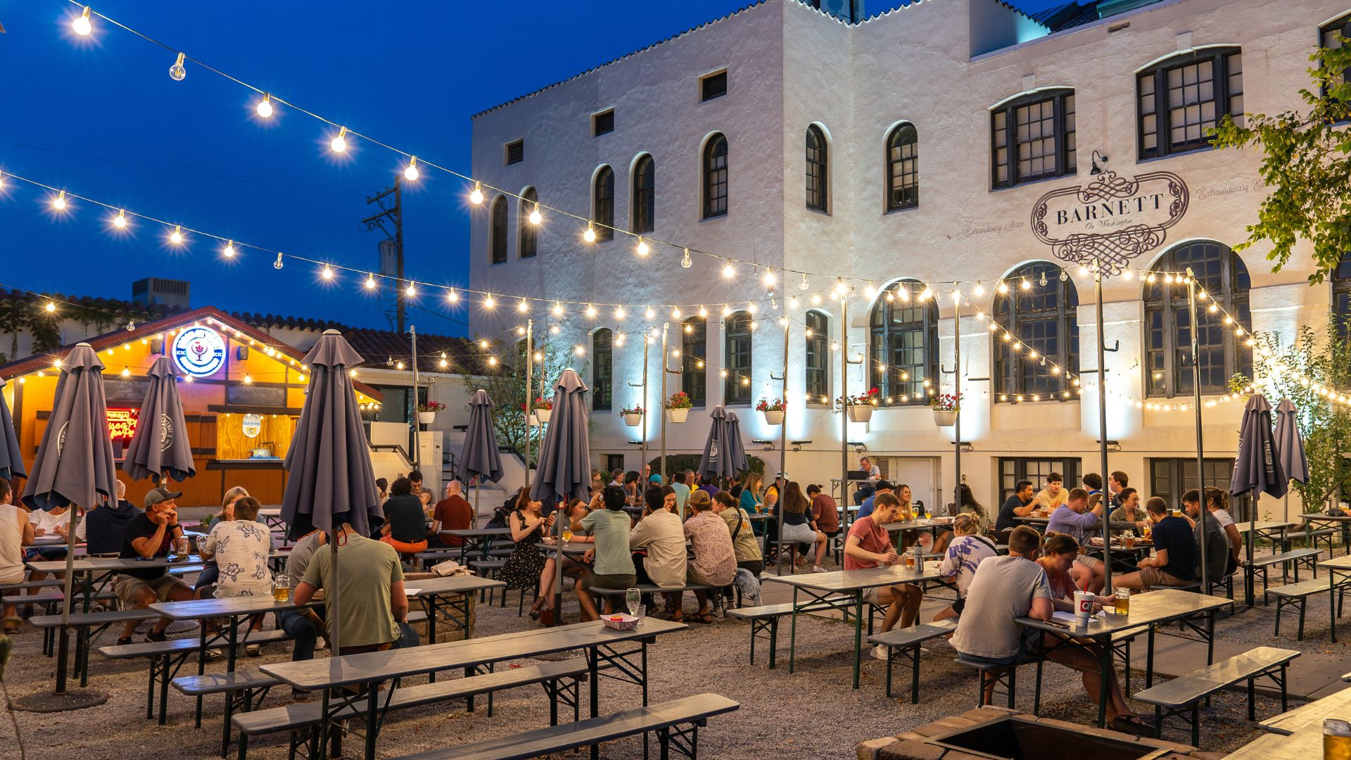 The biergarten at Urban Chestnut Brewing Company in Midtown buzzes with people and twinkle lights.