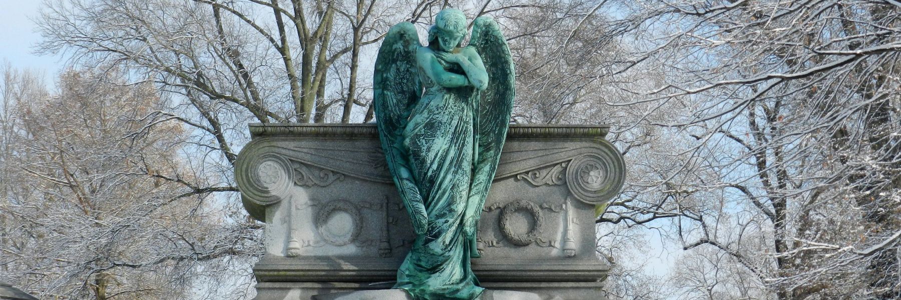 A fresh coat of snow covers a monument at Bellefontaine Cemetery and Arboretum.