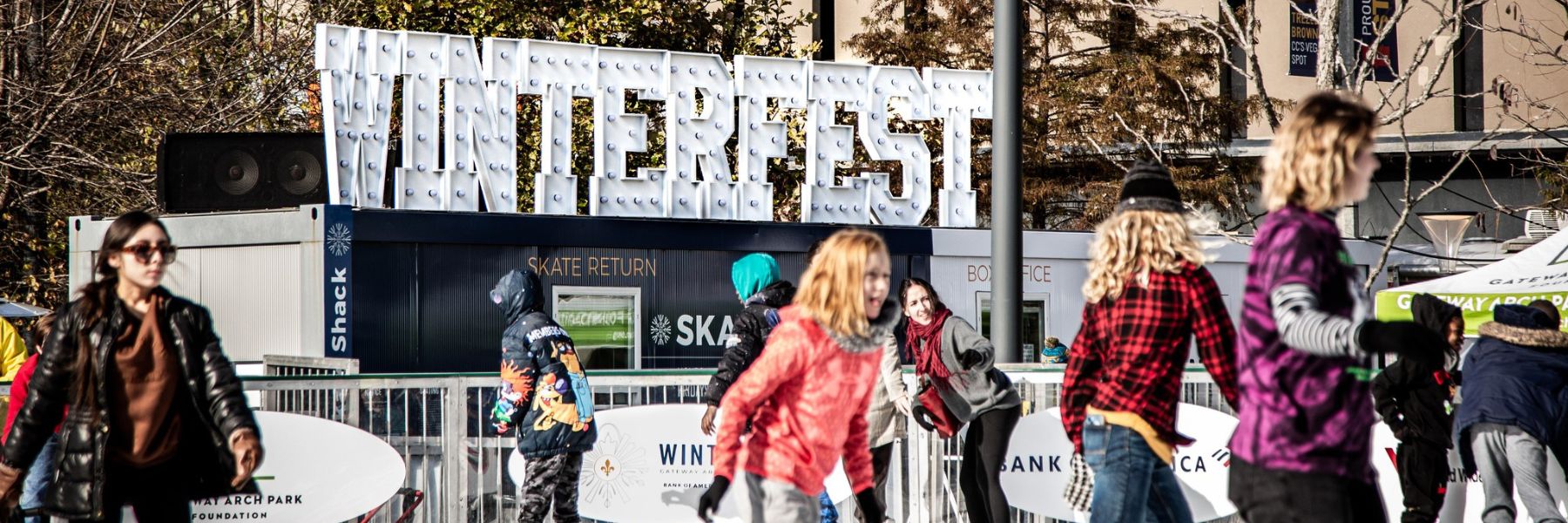 People ice skate at Winterfest in Kiener Plaza.