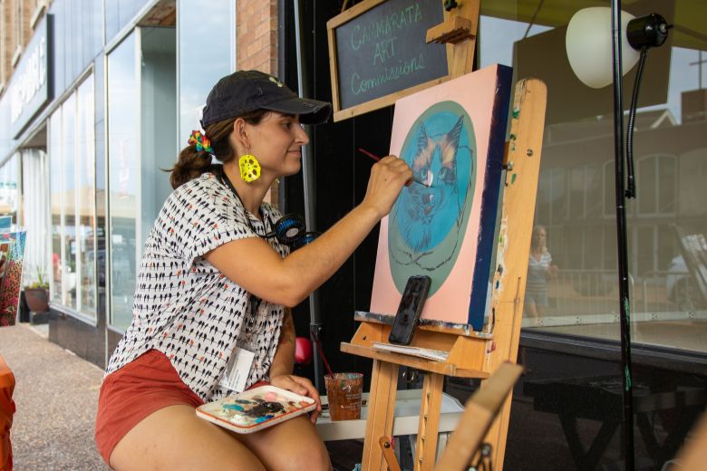 An artist paints at a street festival in Maplewood Missouri.