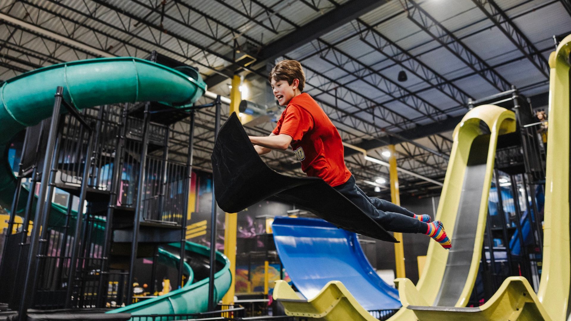 A boy soars through the air after going down a slide at Slick City Action Park in St Louis.