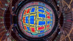 An aerial fish-eye view shows volleyball courts covering the floor of The Dome at America's Center.