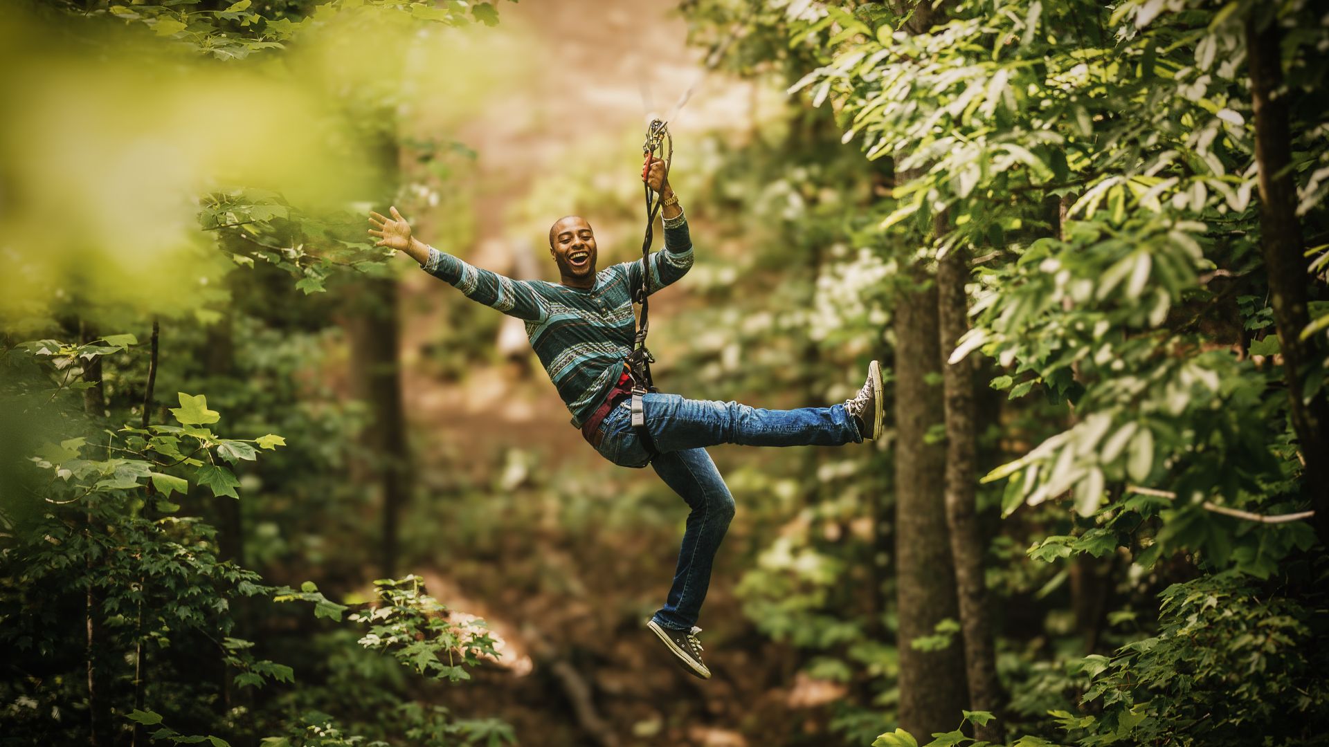 A man screams as he ziplines through Creve Coeur Park.