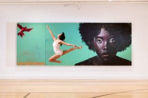 A beautiful female dancer does a leap against an art installation at 21c Museum Hotel St Louis.