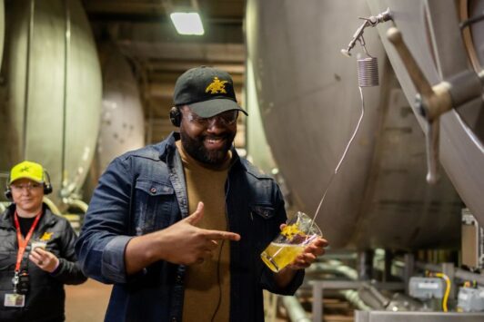 A man enjoys a fresh Budweiser from the finishing tank on a St Louis sightseeing tour at Anheuser-Busch.
