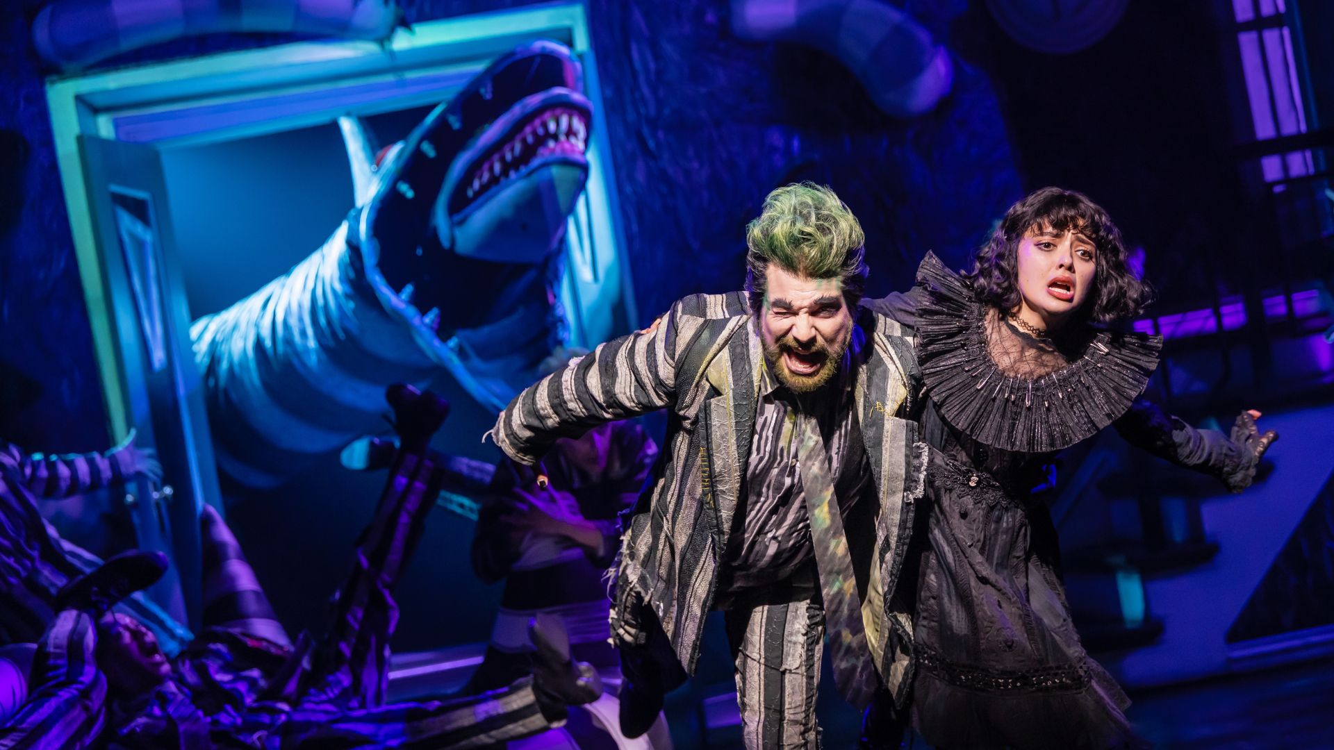 Beetlejuice and Lydia Deetz run from a monster during the musical at The Fabulous Fox.