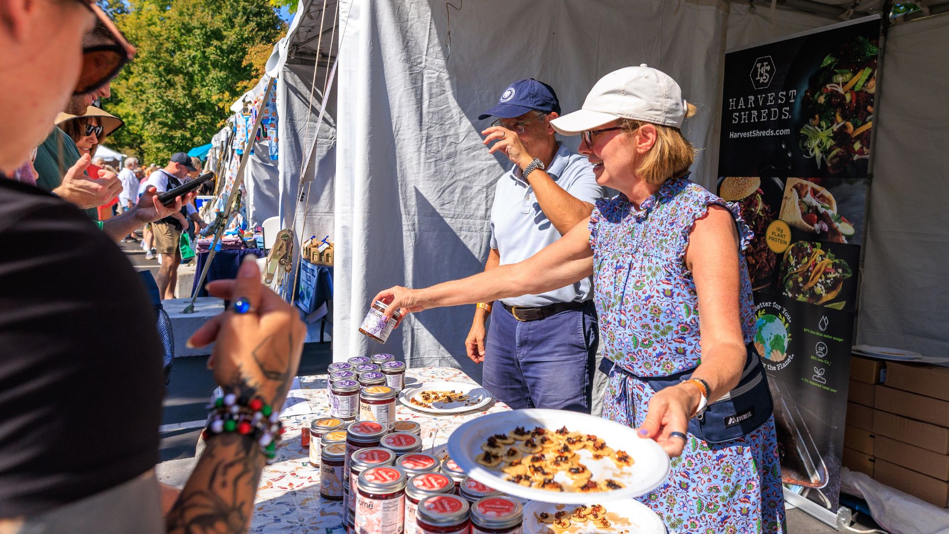 Diverse people shop for chili crisp at the Best of Missouri Market at the Missouri Botanical Garden.