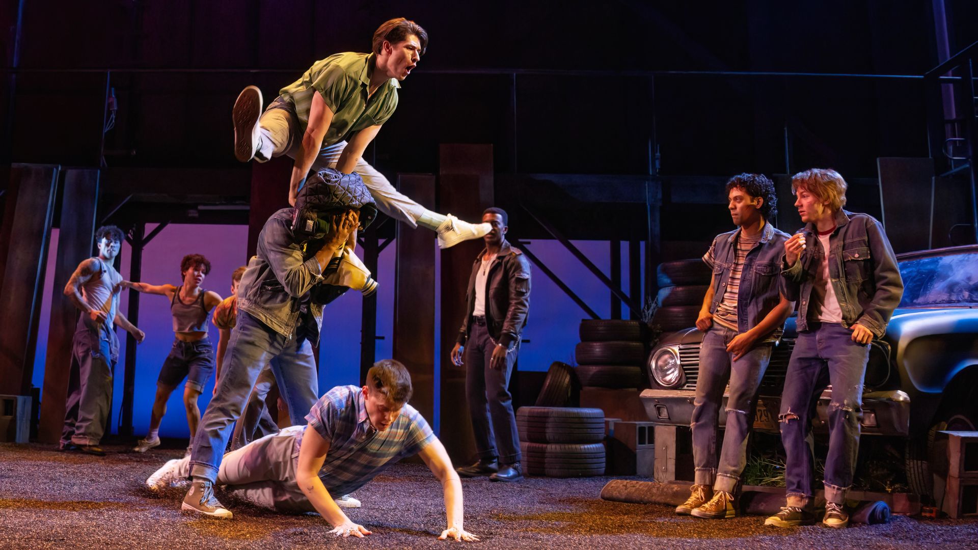 The cast of The Outsiders leap across the stage of The Fabulous Fox.