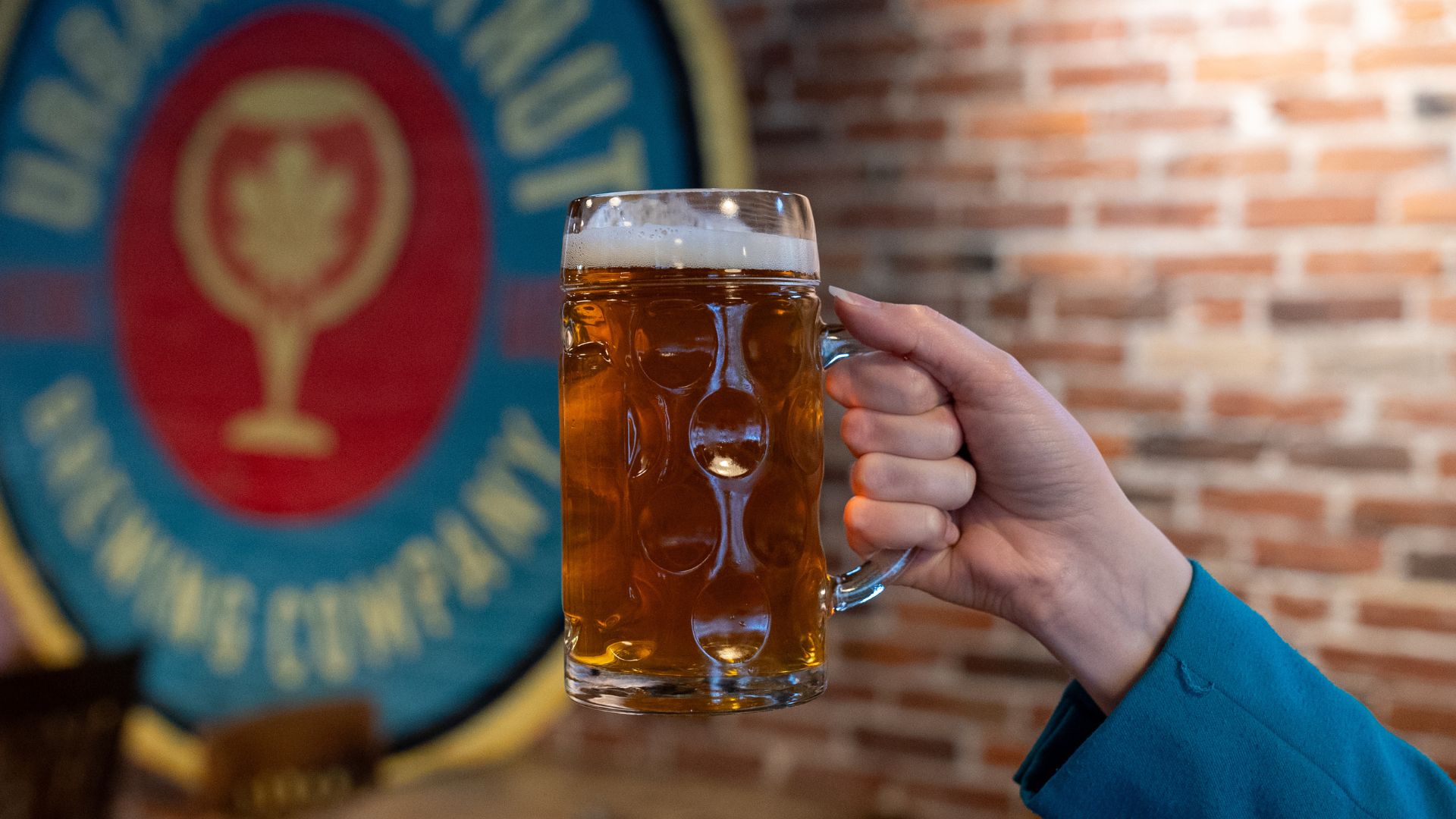 Someone raises a beer stein at Urban Chestnut Brewery.