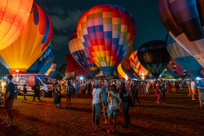 People gather among illuminated hot air balloons in St Louis' Forest Park.