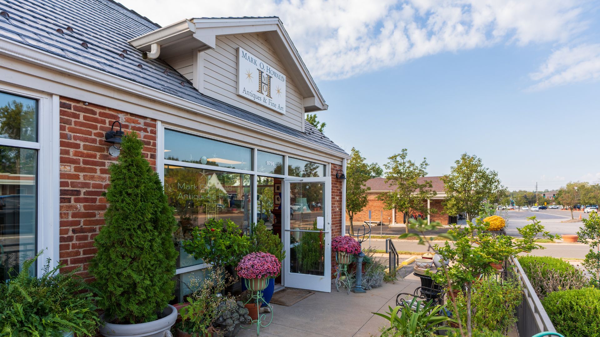 Mark O. Howald Antiques & Fine Art has beautiful landscaping around its front door.