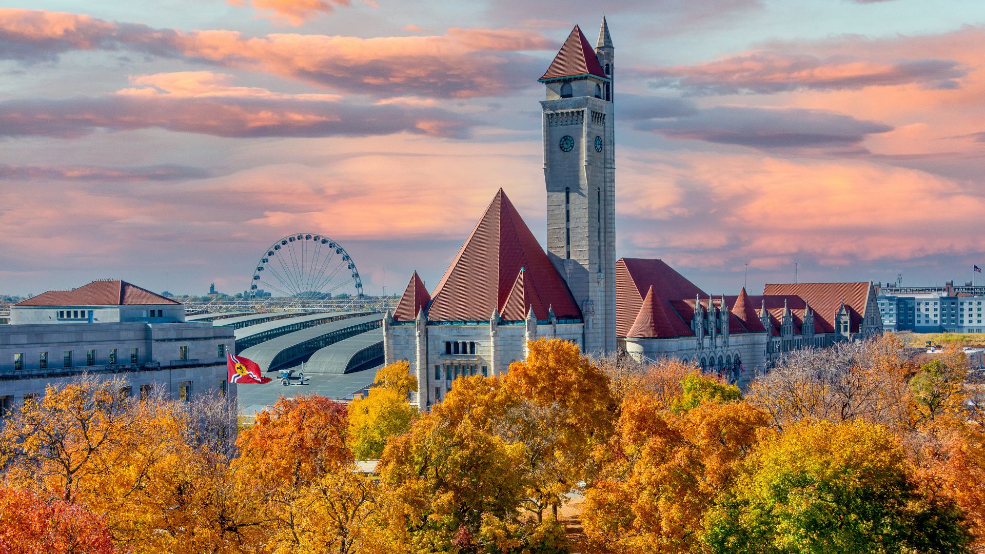 Fall foliage adds seasonal color to this image of St Louis Union Station and the St Louis Wheel at sunset.
