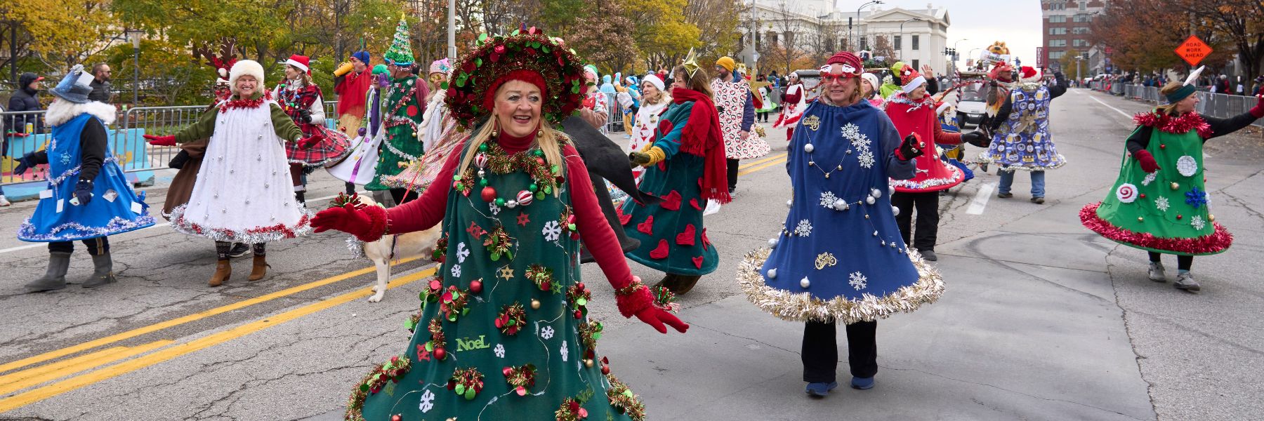 Ladies dressed as Christmas trees dance in the St Louis Thanksgiving parade.