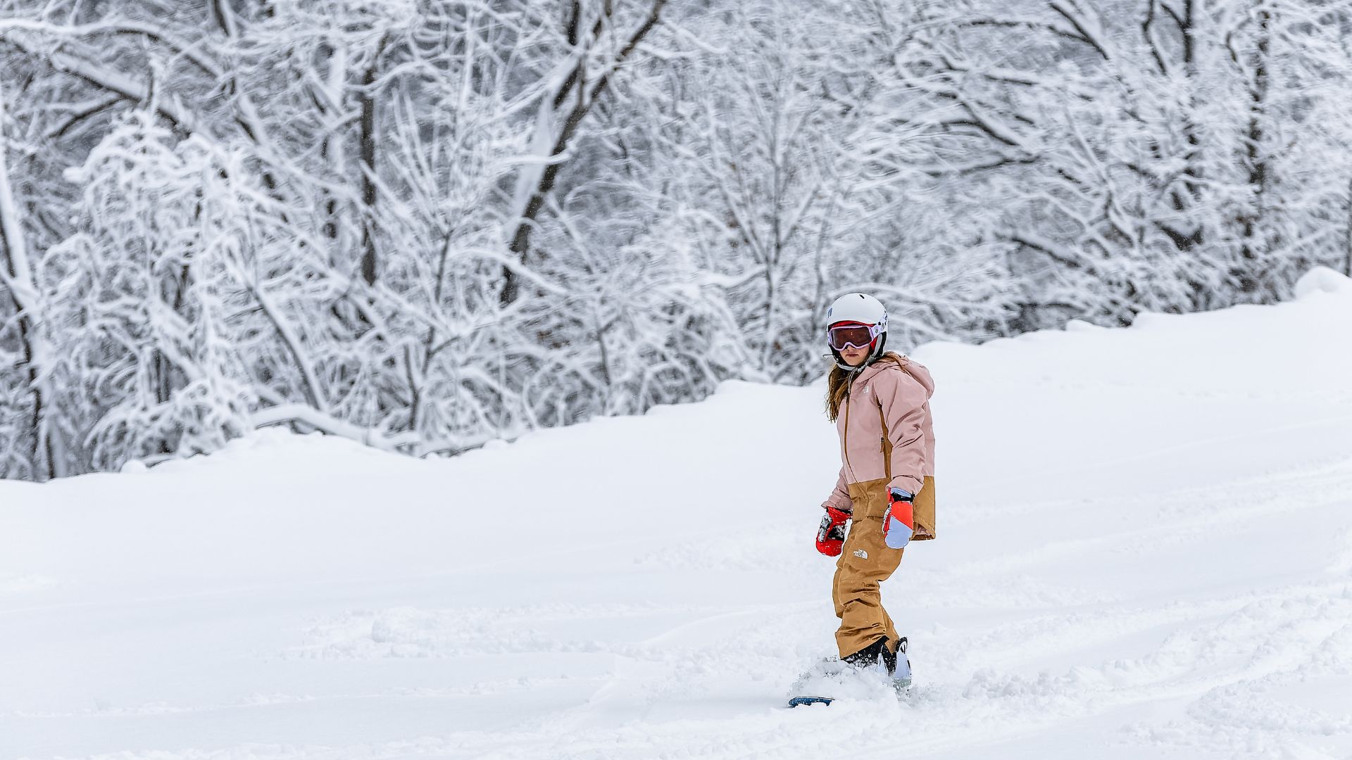 A girl snowboards down on of the runs at Hidden Valley in St Louis.