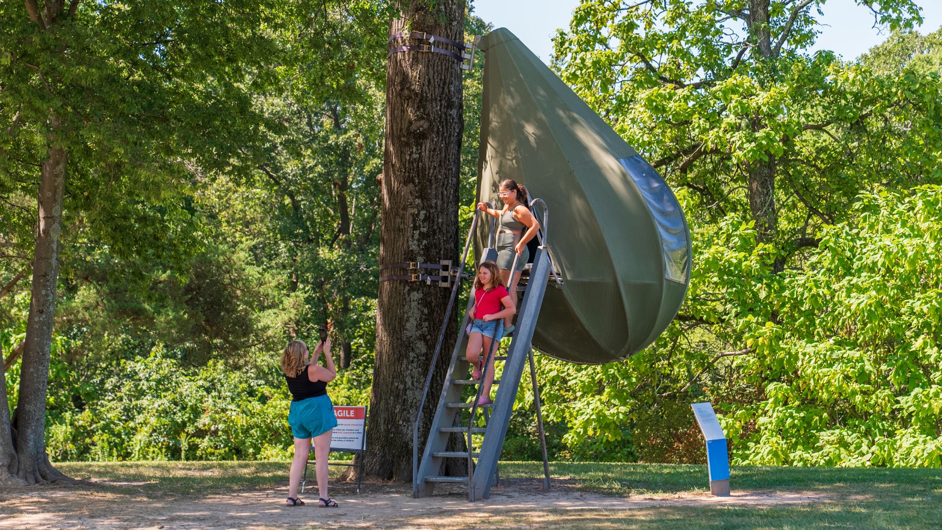 Kids pose for a photo with one of the al fresco sculptures at Laumeier Sculpture Park in St Louis.
