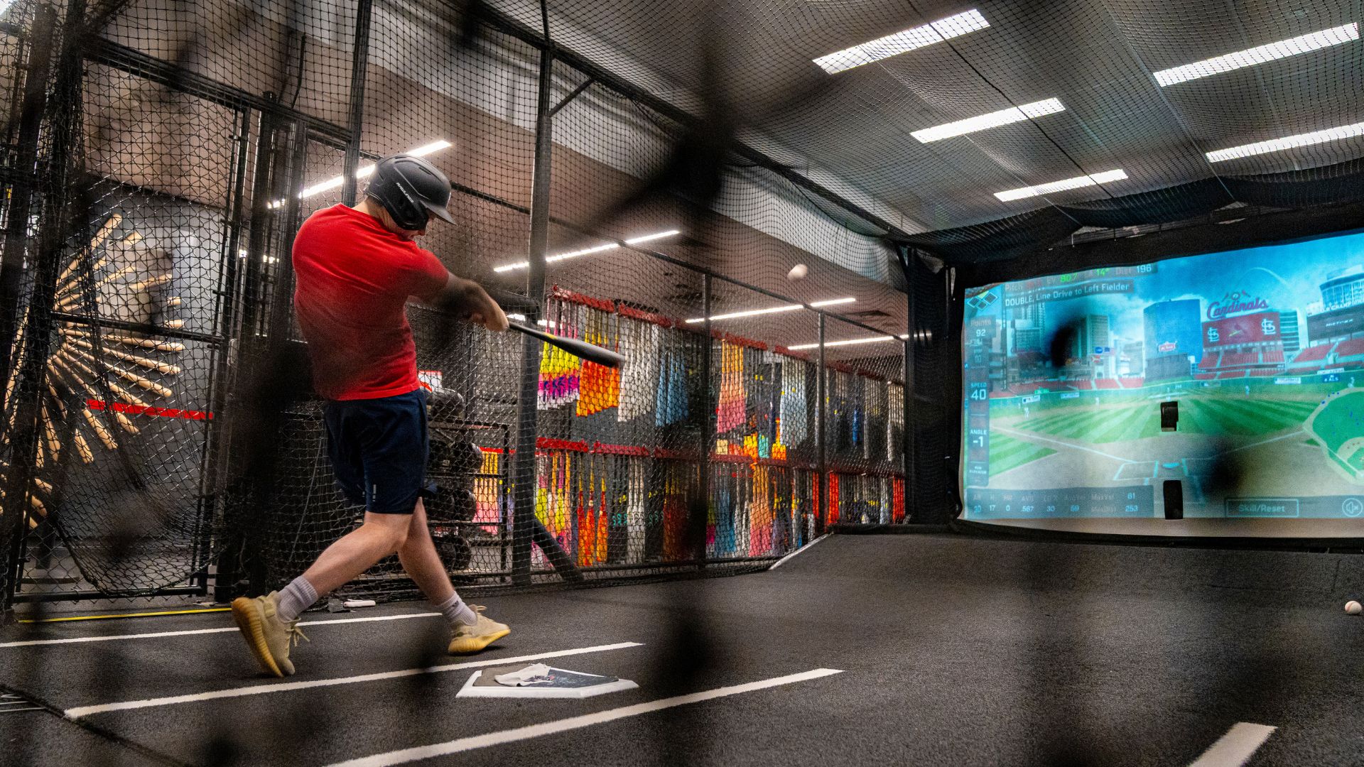 A teenage boy hits a baseball in the batting cages at the Rawlings Experience in St Louis.