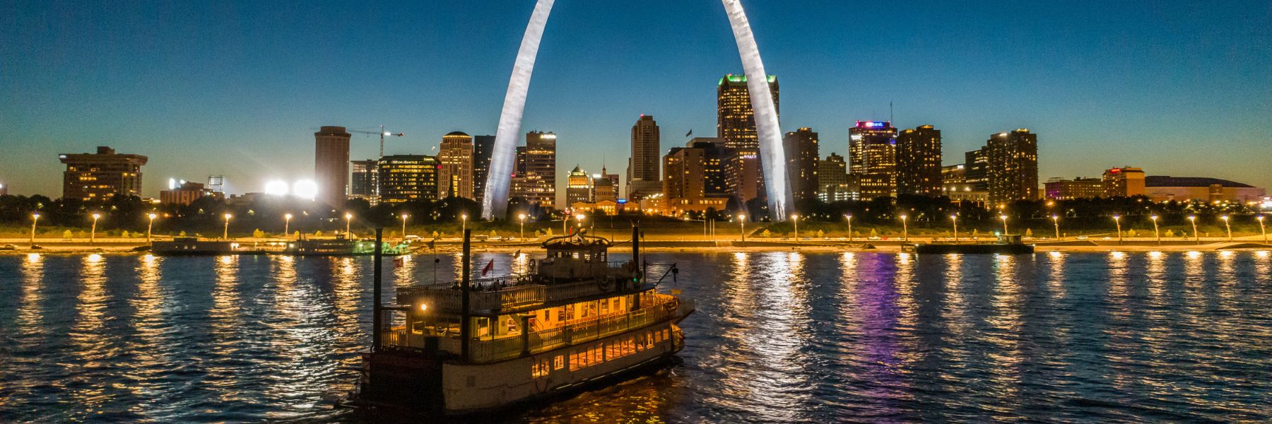 The Riverboats at the Gateway Arch sail in the glow of the St Louis skyline.