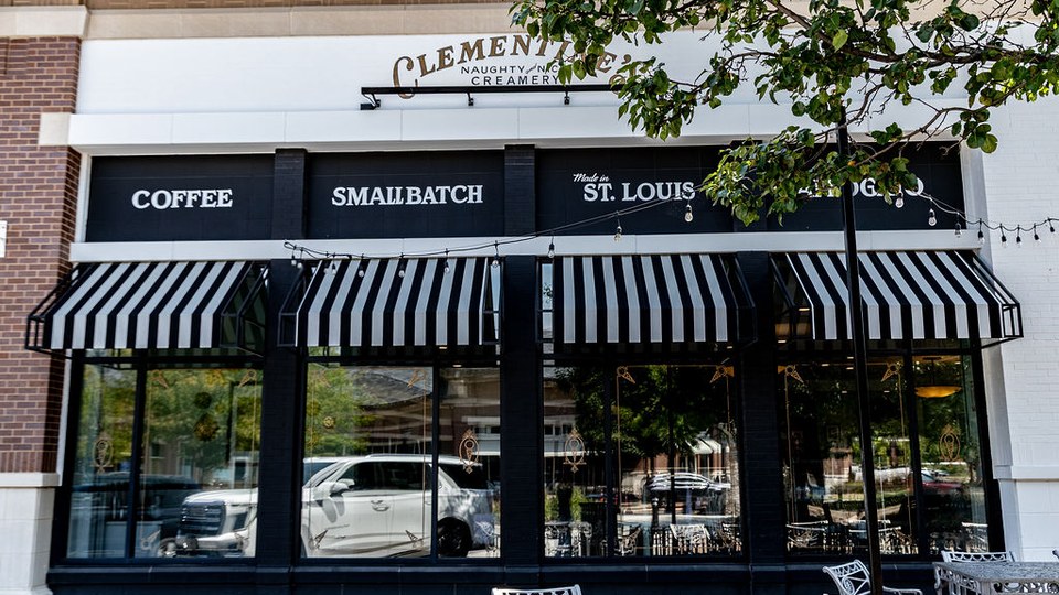 Clementine’s Naughty & Nice Creamery storefront in Lake Saint Louis with black-and-white striped awnings.