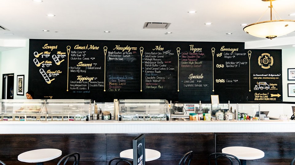 Clementine’s Lake Saint Louis ice cream counter with display cases and a chalkboard menu.