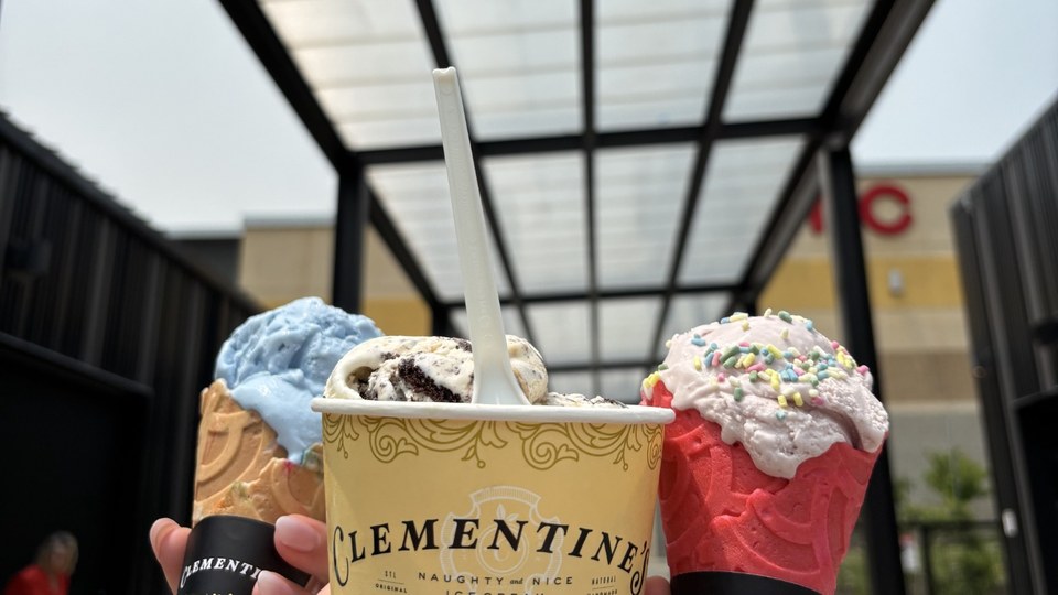 Three Clementine’s ice cream servings, including cones and a cup, held outside the St. Charles location.