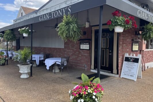 Gian-Tony’s exterior with covered patio seating and hanging flower baskets.