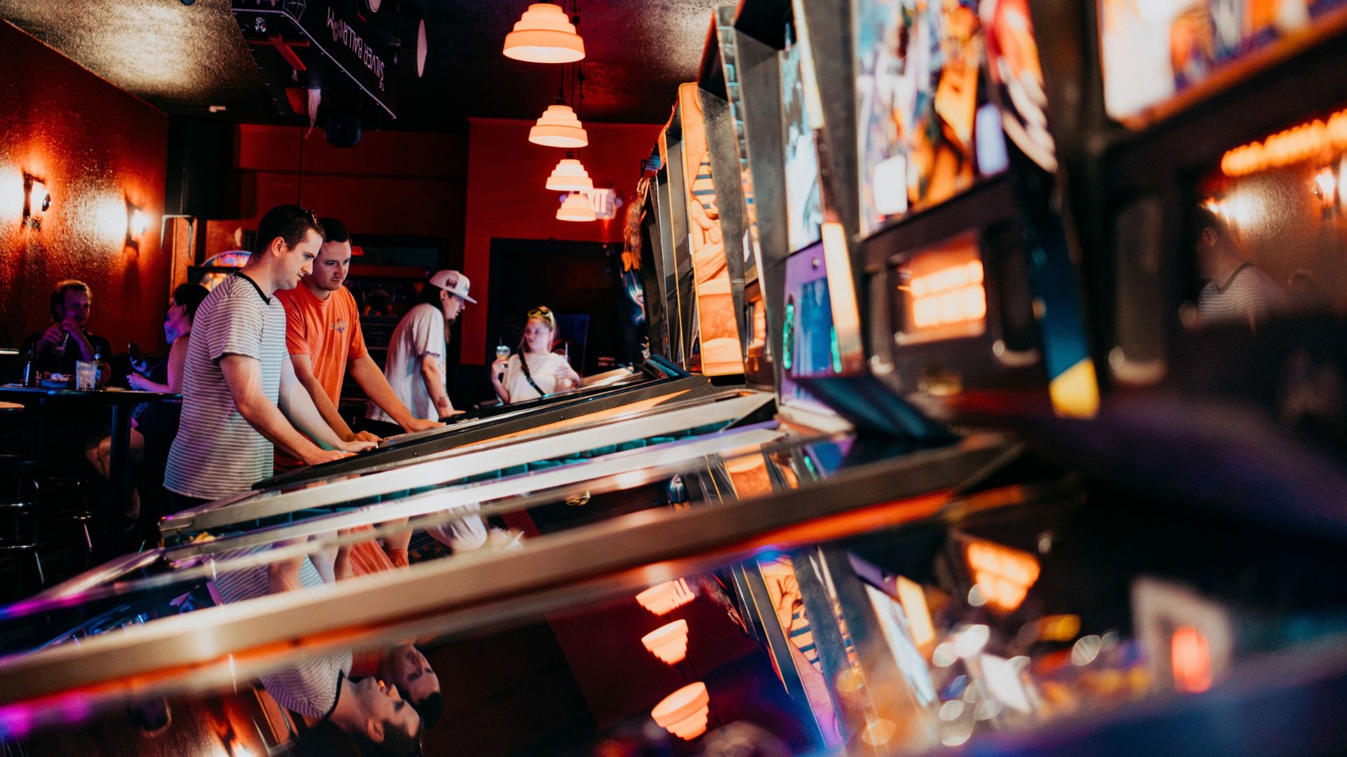 Young couples play pinball at The Silver Ballroom in St Louis.