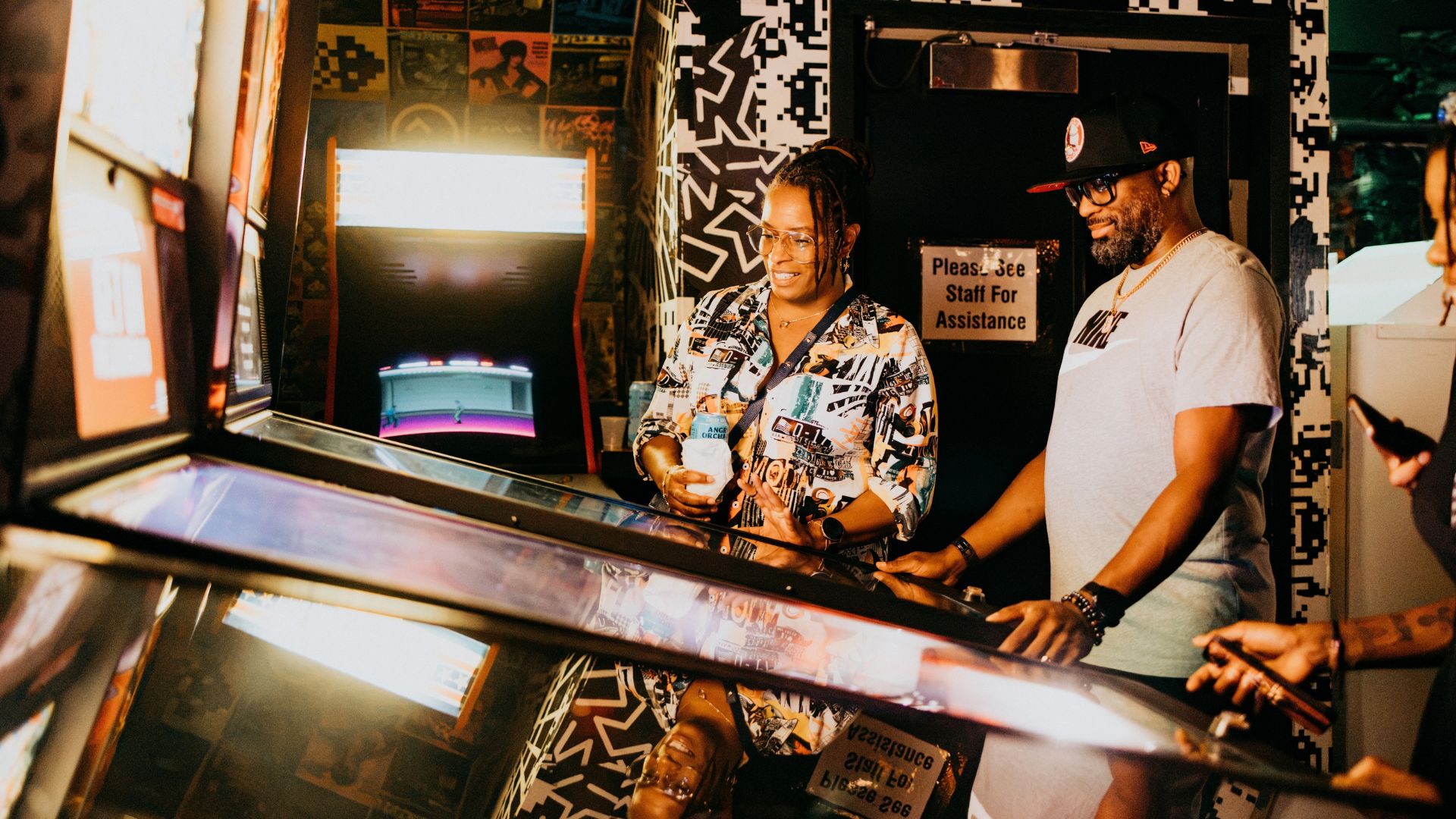 A Black couple plays pinball at Up-Down STL during date night in St Louis.