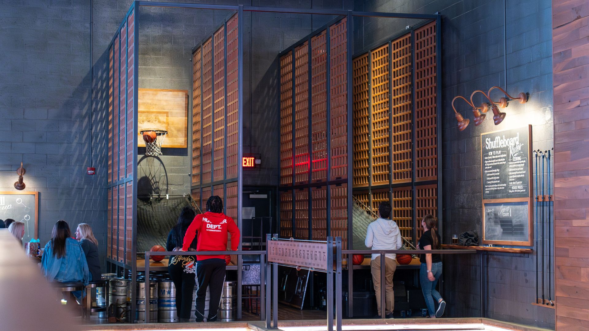 Couples shoot hoops at Westport Social, a great place for a fun date in St Louis.